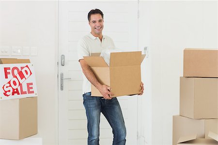 simsearch:400-07930718,k - Portrait of a smiling man carrying boxes in a new house Stock Photo - Budget Royalty-Free & Subscription, Code: 400-07467870