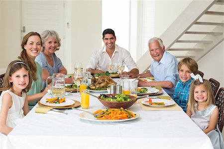 Portrait of smiling multigeneration family having meal together at dining table Stock Photo - Budget Royalty-Free & Subscription, Code: 400-07468435