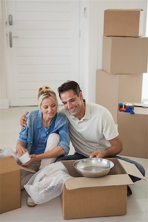 simsearch:400-07930718,k - Happy relaxed couple sitting with boxes in their new house Stock Photo - Budget Royalty-Free & Subscription, Code: 400-07475264