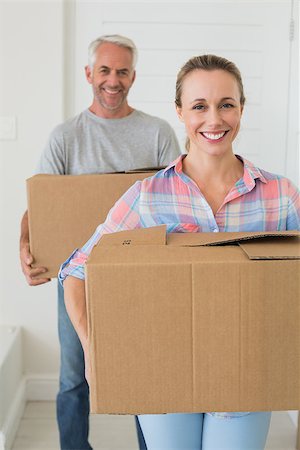 simsearch:400-07930718,k - Happy couple carrying cardboard moving boxes in new home Stock Photo - Budget Royalty-Free & Subscription, Code: 400-07475977