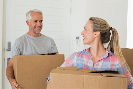 simsearch:400-07927836,k - Happy couple carrying cardboard moving boxes in their new home Stock Photo - Budget Royalty-Free & Subscription, Code: 400-07475978