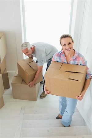 simsearch:400-07930718,k - Happy couple carrying cardboard moving boxes in their new home Stock Photo - Budget Royalty-Free & Subscription, Code: 400-07475979