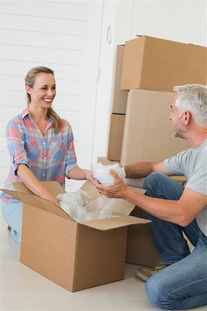 simsearch:400-07927836,k - Happy couple unpacking cardboard moving boxes in their new home Stock Photo - Budget Royalty-Free & Subscription, Code: 400-07475986