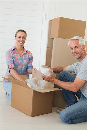 simsearch:400-07927836,k - Happy couple unpacking cardboard moving boxes in their new home Stock Photo - Budget Royalty-Free & Subscription, Code: 400-07475987