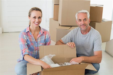 simsearch:400-07927836,k - Happy couple unpacking cardboard moving boxes in their new home Stock Photo - Budget Royalty-Free & Subscription, Code: 400-07475988