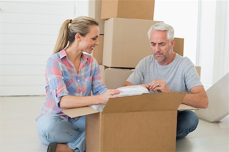 simsearch:400-07927836,k - Happy couple unpacking cardboard moving boxes in their new home Stock Photo - Budget Royalty-Free & Subscription, Code: 400-07475989