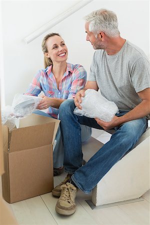 simsearch:400-07927836,k - Happy couple unpacking cardboard moving boxes in their new home Stock Photo - Budget Royalty-Free & Subscription, Code: 400-07475995