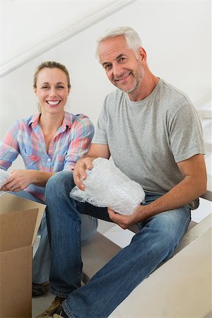 simsearch:400-07927836,k - Happy couple unpacking cardboard moving boxes in their new home Stock Photo - Budget Royalty-Free & Subscription, Code: 400-07475996