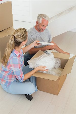 simsearch:400-07927836,k - Happy couple unpacking cardboard moving boxes in their new home Stock Photo - Budget Royalty-Free & Subscription, Code: 400-07475992