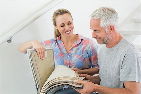 simsearch:400-07927836,k - Happy couple picking out carpet samples together in their new home Stock Photo - Budget Royalty-Free & Subscription, Code: 400-07476025