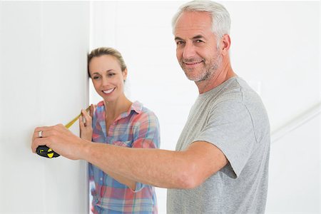 simsearch:400-07927836,k - Happy couple making some measurements together in their new home Stock Photo - Budget Royalty-Free & Subscription, Code: 400-07476026