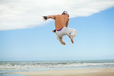 simsearch:400-04347301,k - man is jumping sport karate martial arts fight kick jump beach summertime Photographie de stock - Aubaine LD & Abonnement, Code: 400-07478087