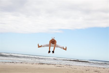 simsearch:400-04347301,k - man is jumping sport karate martial arts fight kick jump beach summertime Photographie de stock - Aubaine LD & Abonnement, Code: 400-07478227