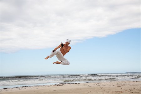 simsearch:400-04347301,k - man is jumping sport karate martial arts fight kick jump beach summertime Photographie de stock - Aubaine LD & Abonnement, Code: 400-07478228