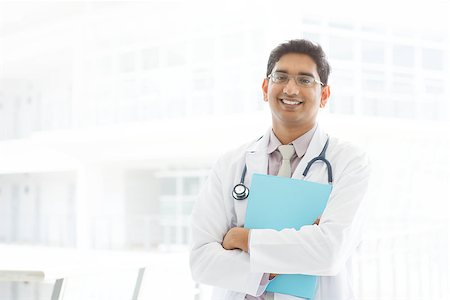 szefei (artist) - Portrait of a smiling Asian Indian male medical doctor standing inside hospital, holding file folder. Stock Photo - Budget Royalty-Free & Subscription, Code: 400-07470865