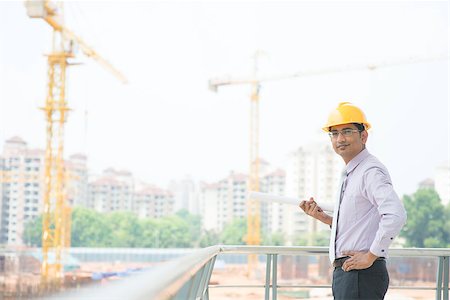 szefei (artist) - Portrait of a smiling Asian Indian male contractor engineer with hard hat standing at construction site. Stock Photo - Budget Royalty-Free & Subscription, Code: 400-07470860
