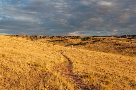 rockies foothills - sunrise over Colorado prairie with a distant mountain biking figure - Soapstone Prairie Natural Area, Fort Collins Stock Photo - Budget Royalty-Free & Subscription, Code: 400-07471046