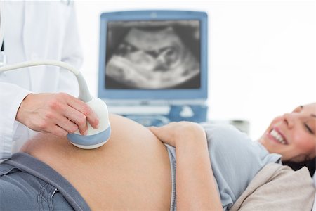 Cropped image of doctor performing ultrasound on pregnant woman in clinic Stock Photo - Budget Royalty-Free & Subscription, Code: 400-07473298