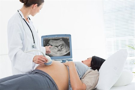 Doctor performing ultrasound on belly of pregnant woman in clinic Stock Photo - Budget Royalty-Free & Subscription, Code: 400-07473300
