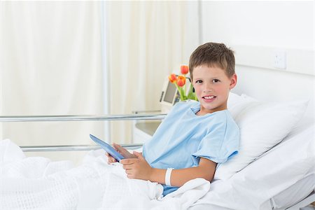 Portrait of little boy using digital tablet in hospital bed Stock Photo - Budget Royalty-Free & Subscription, Code: 400-07473476