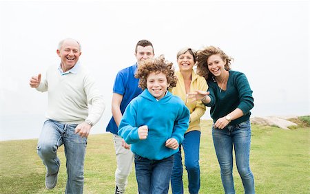 simsearch:400-07426233,k - Happy family running together in the green lawn Stock Photo - Budget Royalty-Free & Subscription, Code: 400-07480727