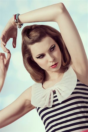 simsearch:400-05739862,k - fashion portrait of charming young girl posing with vintage dress and hair-style. Cute make-up and bracelets Stock Photo - Budget Royalty-Free & Subscription, Code: 400-07481100
