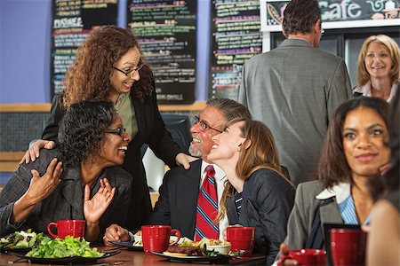 simsearch:400-04099373,k - Four businesspeople laughing together during lunch in cafe Stock Photo - Budget Royalty-Free & Subscription, Code: 400-07507041
