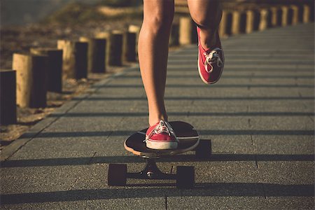 Young woman down the street with a skateboard Stock Photo - Budget Royalty-Free & Subscription, Code: 400-07507518