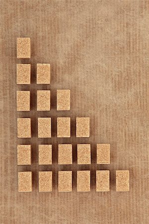 Brown sugar cubes in abstract design over brown paper background. Photographie de stock - Aubaine LD & Abonnement, Code: 400-07507646