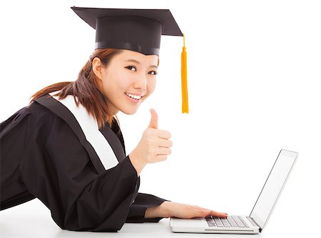 female graduation using a laptop and thumb up Stock Photo - Budget Royalty-Free & Subscription, Code: 400-07514198