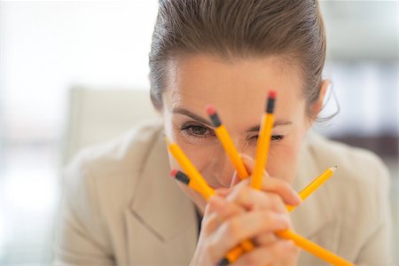 Portrait of business woman holding pencils Stock Photo - Budget Royalty-Free & Subscription, Code: 400-07517366