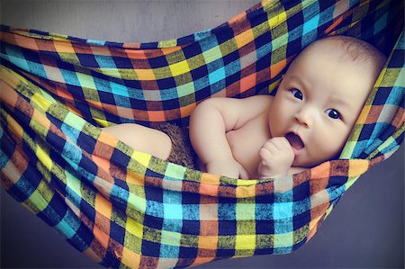 Baby lying in a boat,blanket or vase Stock Photo - Budget Royalty-Free & Subscription, Code: 400-07510537