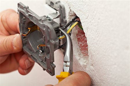 Electrician hands installing wires into electrical outlet - closeup Stock Photo - Budget Royalty-Free & Subscription, Code: 400-07524768