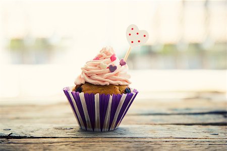 Photo of cute cupcake on wooden background Stock Photo - Budget Royalty-Free & Subscription, Code: 400-07525181