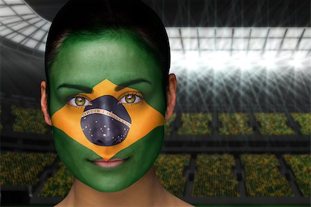 Composite image of beautiful brasil fan in face paint against vast football stadium with fans in yellow Stock Photo - Budget Royalty-Free & Subscription, Code: 400-07525960