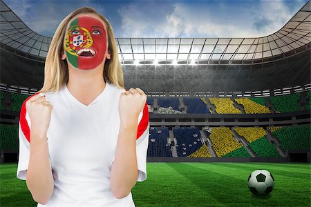 portugal soccer ball - Excited portugal fan in face paint cheering against large football stadium with brasilian fans Stock Photo - Budget Royalty-Free & Subscription, Code: 400-07528215