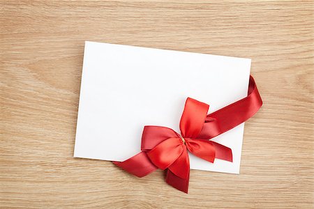 Blank valentines greeting card and red ribbon on wooden background Stock Photo - Budget Royalty-Free & Subscription, Code: 400-07545211