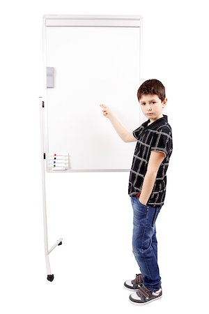pupil in a empty classroom - young boy student in a classroom showing on a empty whiteboard Stock Photo - Budget Royalty-Free & Subscription, Code: 400-07546173