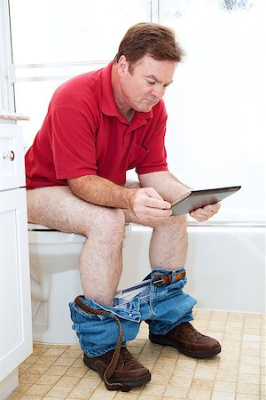 sitting toilet bowl - Man reading a tablet pc while using the toilet in the bathroom. Photographie de stock - Aubaine LD & Abonnement, Code: 400-07554258