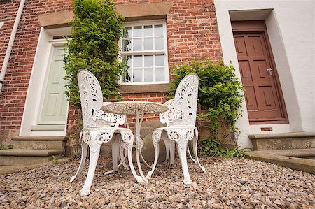 Set of white garden table and chairs on patio outside rural house Photographie de stock - Aubaine LD & Abonnement, Code: 400-07557599