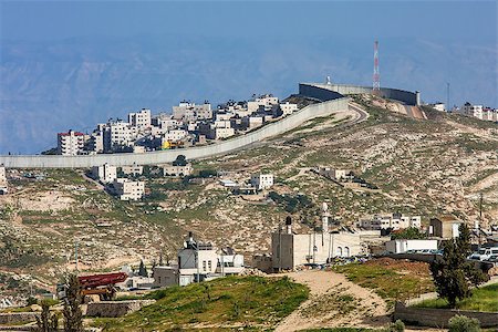 Small village and palestinian town on the hill behind israeli separation barrier on the West Bank in Israel. Stock Photo - Budget Royalty-Free & Subscription, Code: 400-07550311