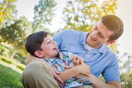 Loving Young Father Tickling Son in the Park. Stock Photo - Budget Royalty-Free & Subscription, Code: 400-07553577