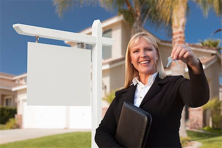 simsearch:700-03508131,k - Female Real Estate Agent Handing Over the House Keys in Front of a Beautiful New Home and Blank Real Estate Sign. Stock Photo - Budget Royalty-Free & Subscription, Code: 400-07553593