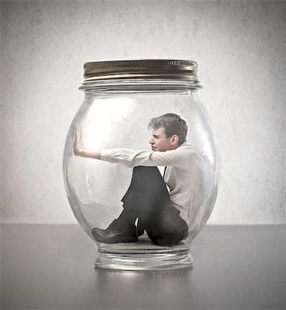 suffocated - Young businessman trying to escape from a big glass bubble Stock Photo - Budget Royalty-Free & Subscription, Code: 400-07567497