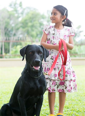Cute Indian girl with her labrador retriever pet dog at outdoor park. Stock Photo - Budget Royalty-Free & Subscription, Code: 400-07574719