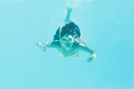 Brunette swimming underwater wearing snorkel on her holidays Stock Photo - Budget Royalty-Free & Subscription, Code: 400-07583860