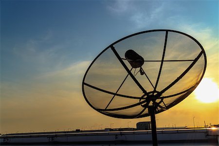 radar parabolic antenna - Satellite dish in the sunset on construction building. Stock Photo - Budget Royalty-Free & Subscription, Code: 400-07616829