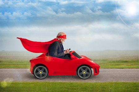 funny images of people driving - senior superhero with mask and cape driving a toy sports car Stock Photo - Budget Royalty-Free & Subscription, Code: 400-07626514
