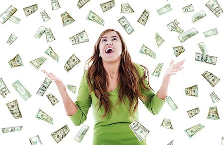 Stock image of ecstatic woman trying to catch falling money Stock Photo - Budget Royalty-Free & Subscription, Code: 400-07620993