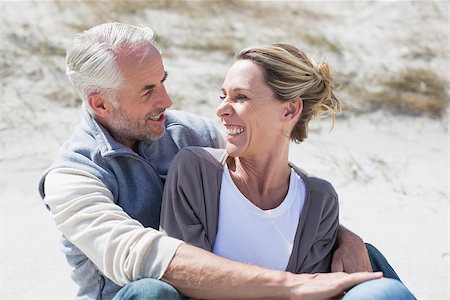 Attractive couple smiling at each other on the beach on a bright but cool day Stock Photo - Budget Royalty-Free & Subscription, Code: 400-07622657